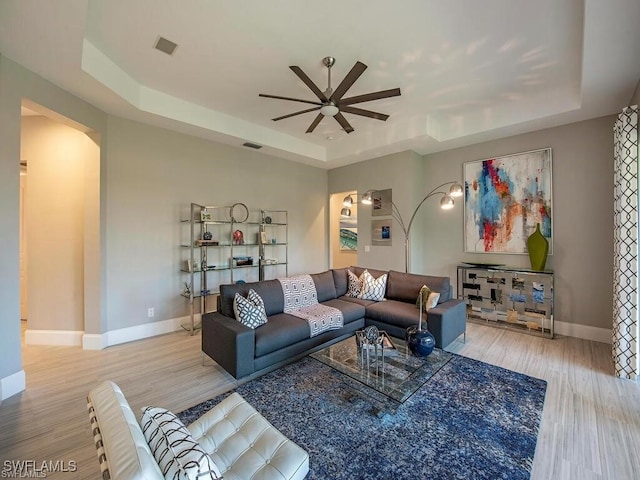 2452 Terra Verde Ln Unit 2452, Naples, FL 34105 - living room with a tray ceiling, ceiling fan, baseboards, and wood finished floors