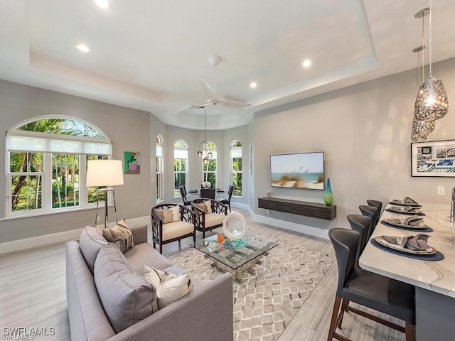2452 Terra Verde Ln Unit 2452, Naples, FL 34105 - living room featuring a raised ceiling, wood finished floors, recessed lighting, baseboards, and a ceiling fan
