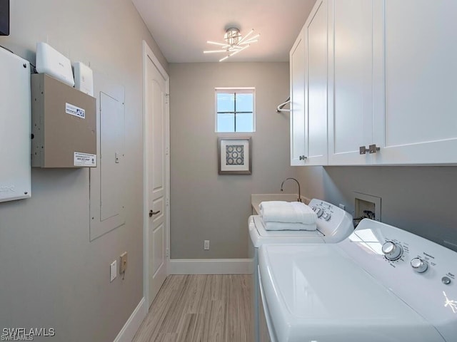 2452 Terra Verde Ln Unit 2452, Naples, FL 34105 - washroom with cabinet space, light wood-style floors, independent washer and dryer, and baseboards