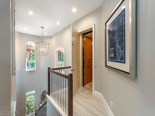 2452 Terra Verde Ln Unit 2452, Naples, FL 34105 - hall featuring an upstairs landing, a chandelier, baseboards, light wood-style floors, and recessed lighting