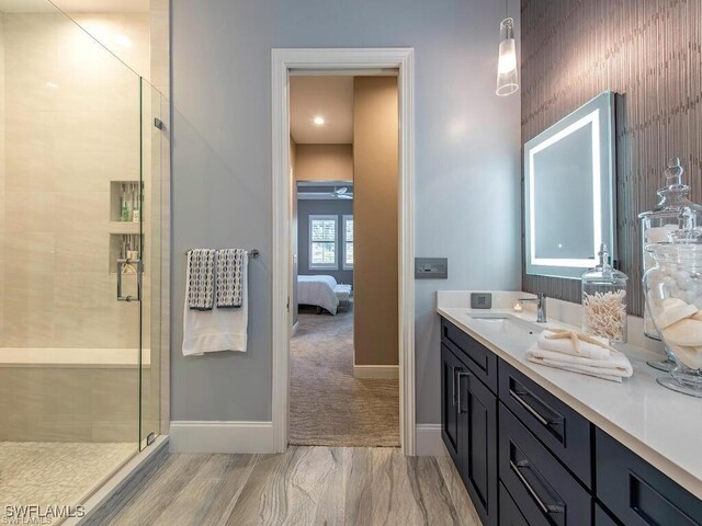 2452 Terra Verde Ln Unit 2452, Naples, FL 34105 - bathroom featuring baseboards, a stall shower, vanity, connected bathroom, and ceiling fan