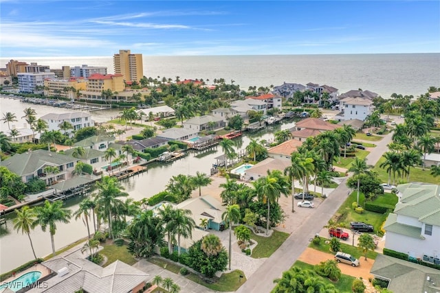 aerial view of residential area featuring a large body of water