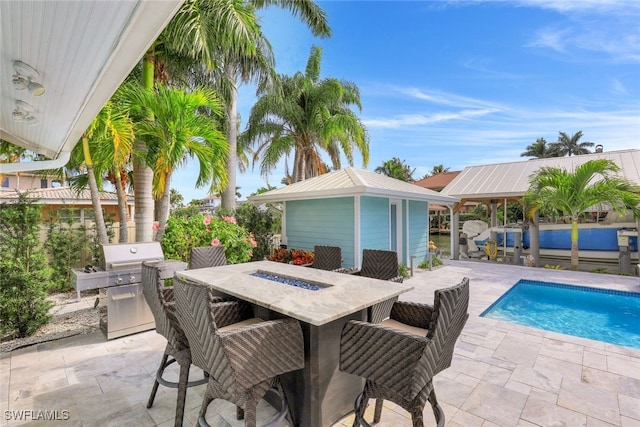 view of swimming pool featuring grilling area, a patio, and outdoor dining area