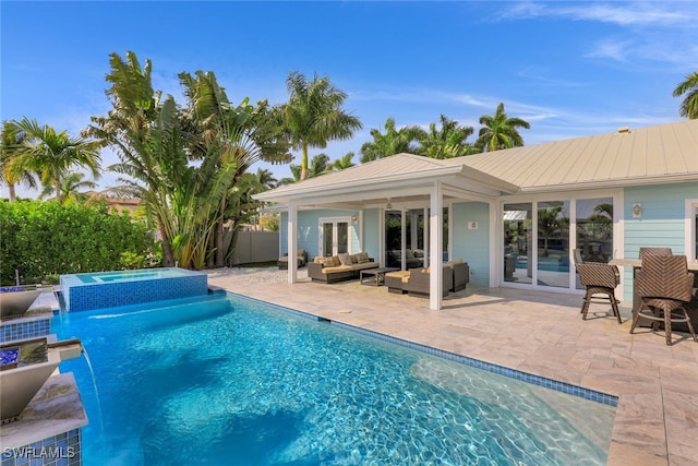 view of pool with an outdoor hangout area, an in-ground hot tub, and a patio area