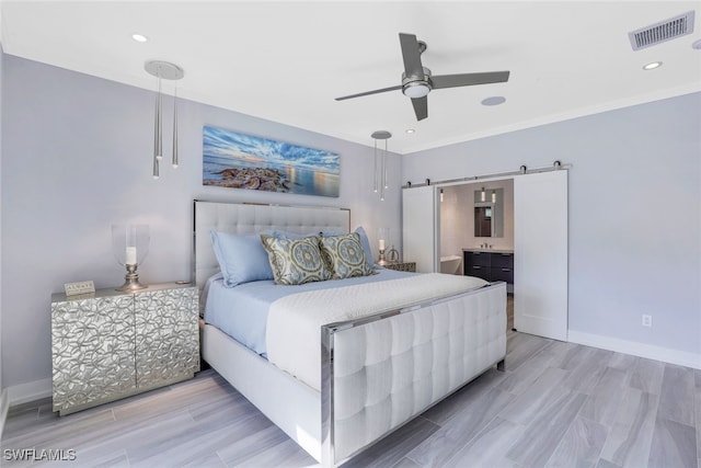 bedroom featuring a barn door, baseboards, recessed lighting, ceiling fan, and light wood finished floors