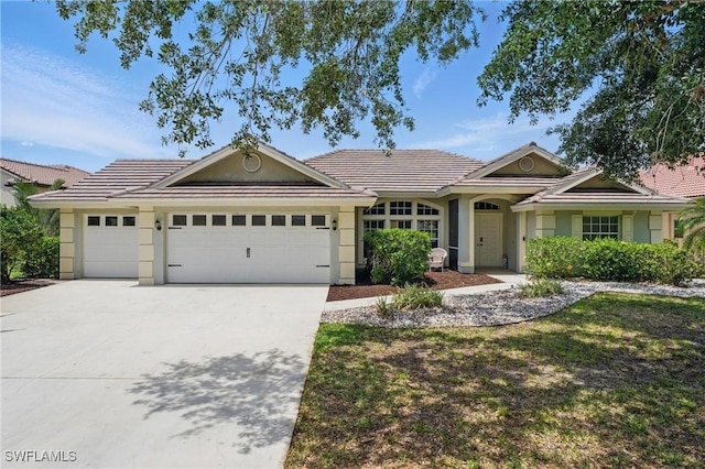 2246 Oxford Ridge Cir, Lehigh Acres, FL 33973 - ranch-style home featuring a garage, driveway, a tile roof, and stucco siding