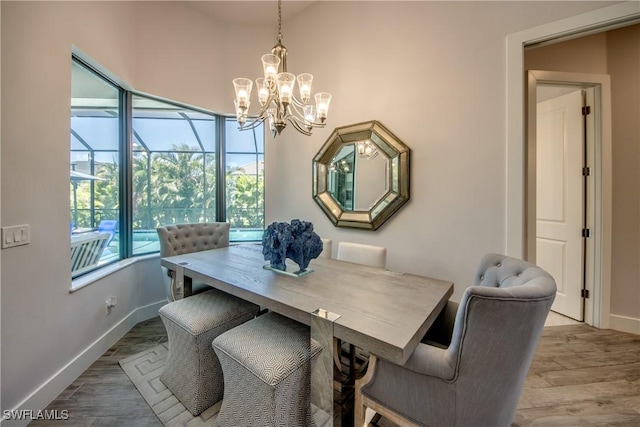 3726 Ceitus Pkwy, Cape Coral, FL 33991 - dining space featuring baseboards, a chandelier, and wood finished floors