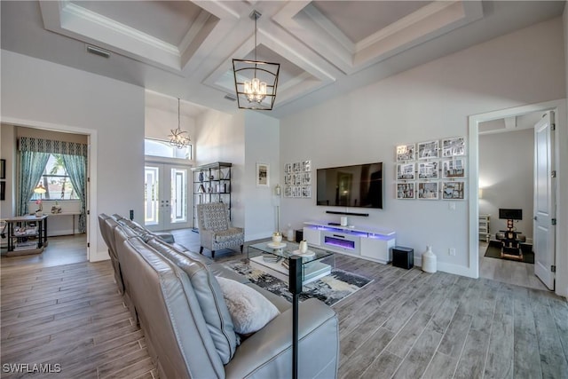 3726 Ceitus Pkwy, Cape Coral, FL 33991 - living area featuring a chandelier, wood finished floors, coffered ceiling, a high ceiling, and french doors