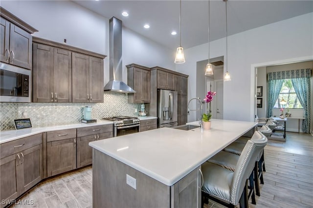 3726 Ceitus Pkwy, Cape Coral, FL 33991 - kitchen featuring stainless steel appliances, a sink, wall chimney exhaust hood, decorative backsplash, and an island with sink