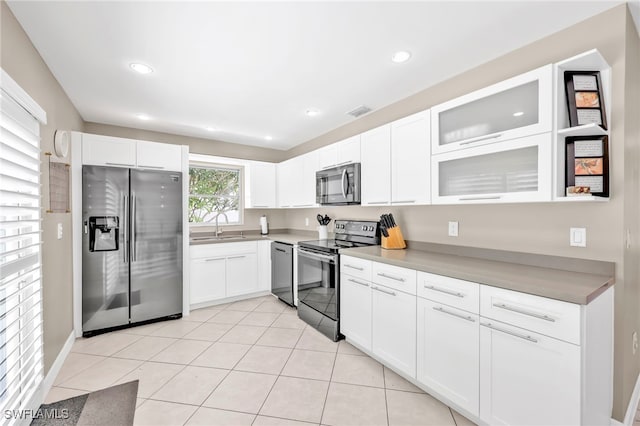 5397 25th Ave SW, Naples, FL 34116 - kitchen with appliances with stainless steel finishes, a sink, white cabinets, glass insert cabinets, and recessed lighting
