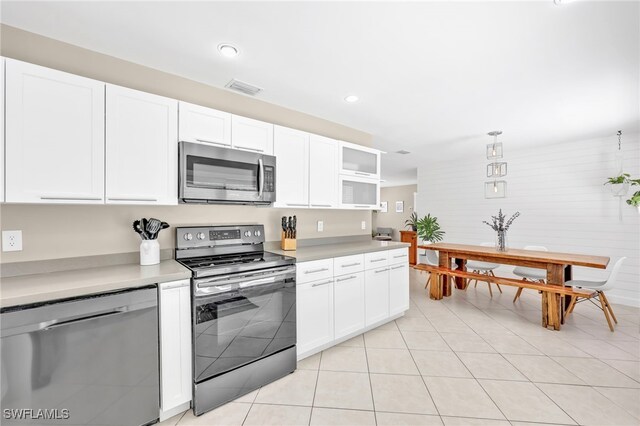 5397 25th Ave SW, Naples, FL 34116 - kitchen featuring stainless steel appliances, white cabinets, light countertops, and recessed lighting