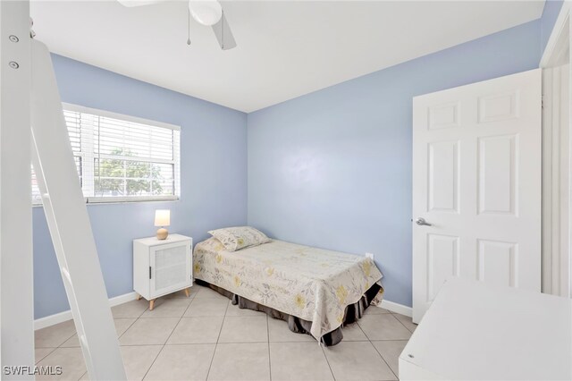 5397 25th Ave SW, Naples, FL 34116 - bedroom with baseboards, light tile patterned floors, and a ceiling fan