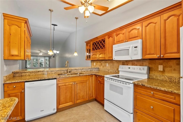 3450 Frosty Way Unit 5210, Naples, FL 34112 - kitchen with white appliances, a sink, a ceiling fan, tasteful backsplash, and brown cabinetry