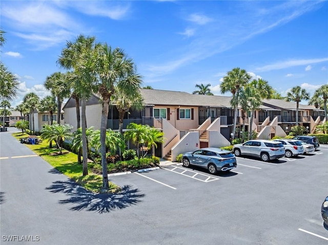 3450 Frosty Way Unit 5210, Naples, FL 34112 - view of building exterior featuring a residential view and uncovered parking