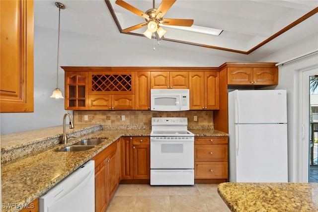 3450 Frosty Way Unit 5210, Naples, FL 34112 - kitchen with white appliances, a sink, brown cabinetry, backsplash, and vaulted ceiling