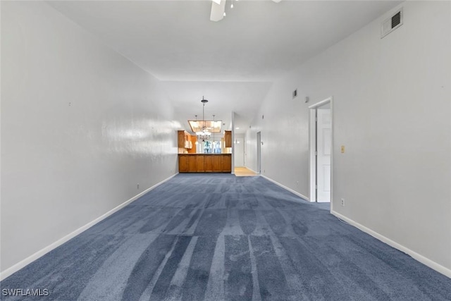 3450 Frosty Way Unit 5210, Naples, FL 34112 - unfurnished living room with a chandelier, dark colored carpet, and baseboards