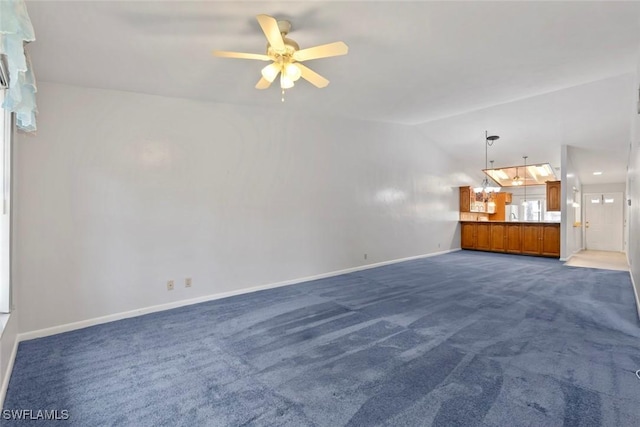 3450 Frosty Way Unit 5210, Naples, FL 34112 - unfurnished living room featuring a ceiling fan, dark colored carpet, vaulted ceiling, and baseboards