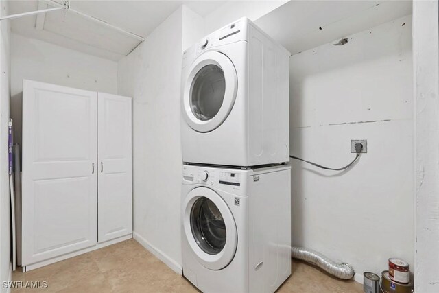 3450 Frosty Way Unit 5210, Naples, FL 34112 - laundry room featuring stacked washer and clothes dryer