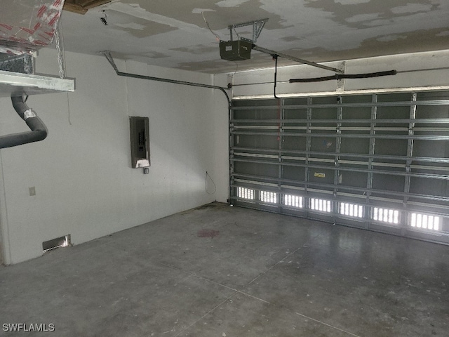 garage with electric panel and a garage door opener