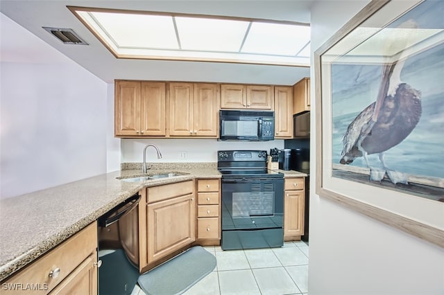 600 Neapolitan Way Unit 153, Naples, FL 34103 - kitchen with black appliances, light tile patterned floors, light stone countertops, and light brown cabinets