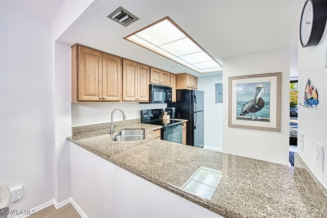 600 Neapolitan Way Unit 153, Naples, FL 34103 - kitchen featuring black appliances and electric panel