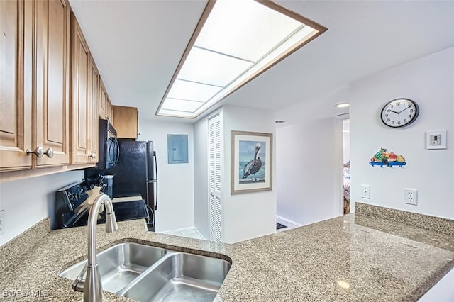 600 Neapolitan Way Unit 153, Naples, FL 34103 - kitchen featuring black appliances, electric panel, brown cabinetry, light stone countertops, and a peninsula