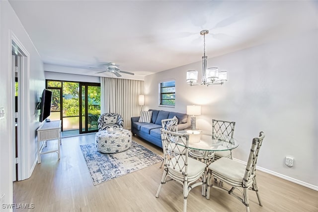 600 Neapolitan Way Unit 153, Naples, FL 34103 - dining space featuring wood finished floors, ceiling fan, and a chandelier