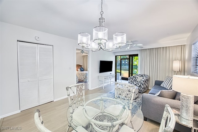 600 Neapolitan Way Unit 153, Naples, FL 34103 - dining area with ceiling fan, light wood-style flooring, and a chandelier