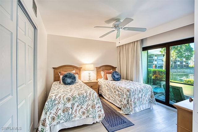 600 Neapolitan Way Unit 153, Naples, FL 34103 - bedroom with access to exterior, wood finished floors, ceiling fan, and a closet