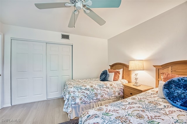 600 Neapolitan Way Unit 153, Naples, FL 34103 - bedroom featuring wood finished floors, a closet, and ceiling fan