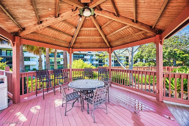 600 Neapolitan Way Unit 153, Naples, FL 34103 - wooden deck with a gazebo and outdoor dining area