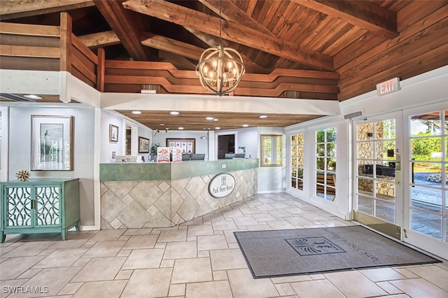 600 Neapolitan Way Unit 153, Naples, FL 34103 - reception area with high vaulted ceiling, a chandelier, a wooden ceiling with exposed beams, and wood walls