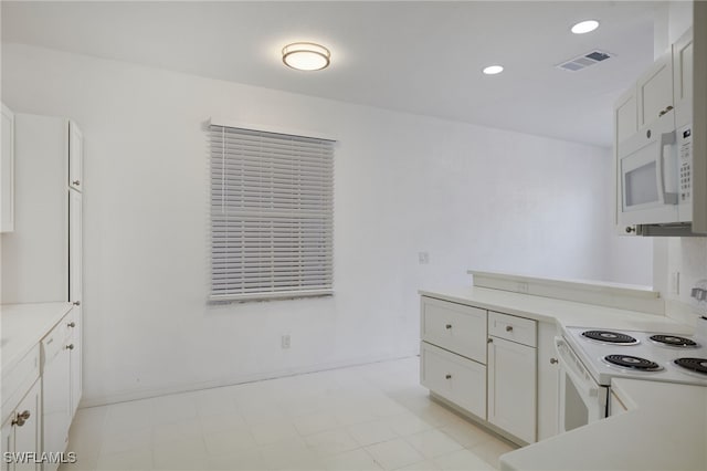 14541 Daffodil Dr Unit 1702, Fort Myers, FL 33919 - kitchen featuring white appliances, light countertops, baseboards, and recessed lighting