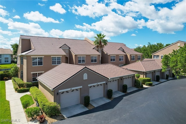 14541 Daffodil Dr Unit 1702, Fort Myers, FL 33919 - view of front of house featuring stucco siding, a tile roof, and a residential view