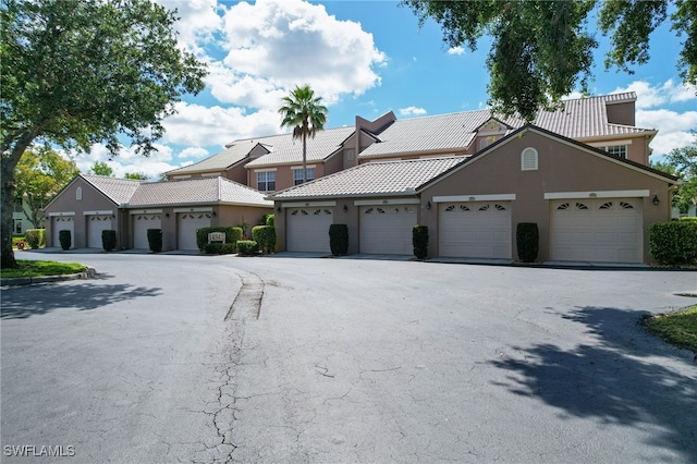 14541 Daffodil Dr Unit 1702, Fort Myers, FL 33919 - multi unit property with stucco siding, community garages, and a tile roof