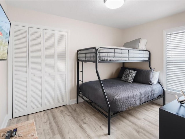 698 99th Ave N, Naples, FL 34108 - bedroom featuring wood finished floors, a closet, and baseboards