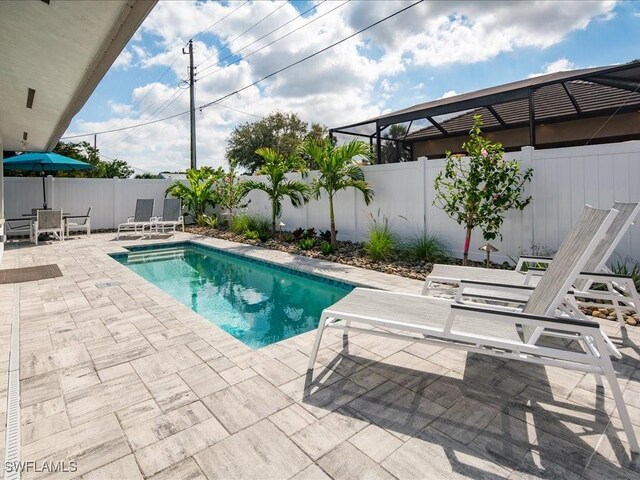 698 99th Ave N, Naples, FL 34108 - view of pool featuring a patio area, a fenced backyard, and outdoor dining area
