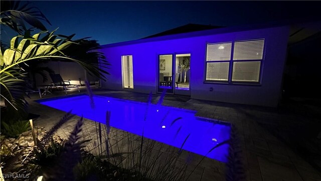 698 99th Ave N, Naples, FL 34108 - pool at twilight with a patio area and an outdoor pool