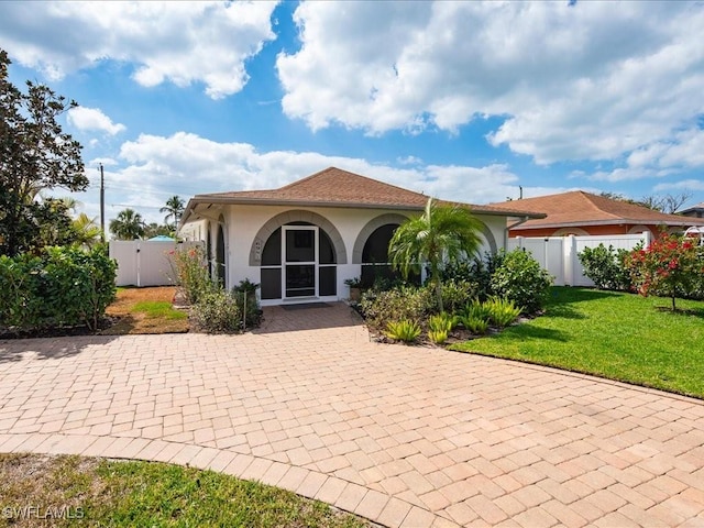 698 99th Ave N, Naples, FL 34108 - back of property featuring stucco siding and a gate