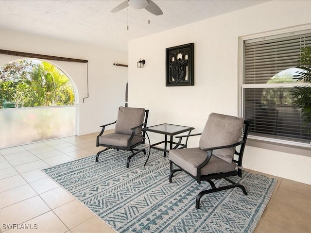 698 99th Ave N, Naples, FL 34108 - living area featuring a ceiling fan, tile patterned floors, and a textured ceiling