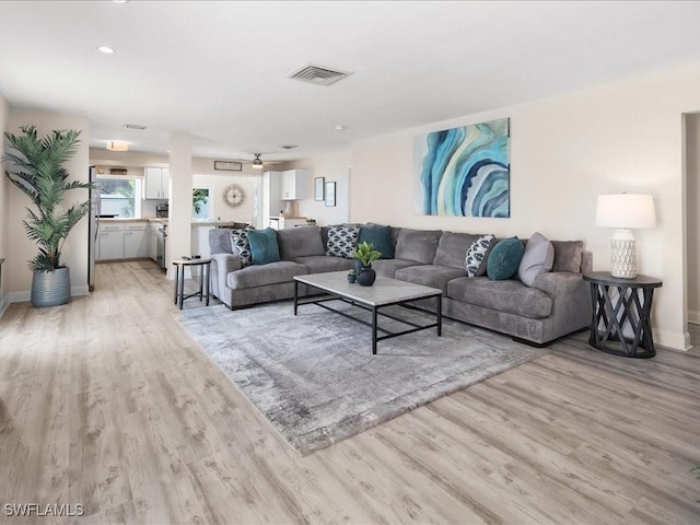 698 99th Ave N, Naples, FL 34108 - living room featuring light wood-style flooring and baseboards