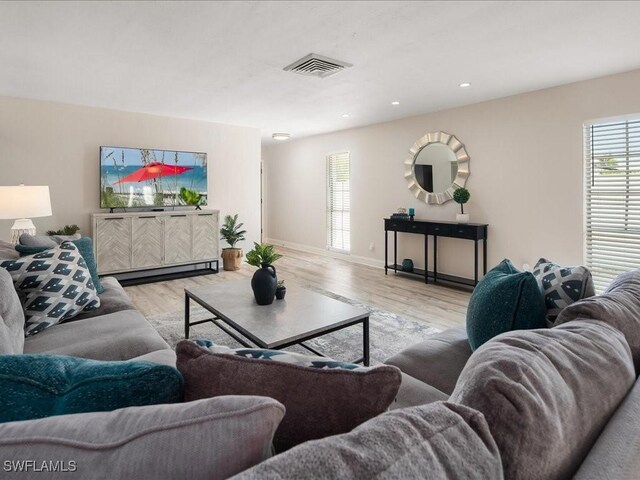 698 99th Ave N, Naples, FL 34108 - living room with wood finished floors, baseboards, and recessed lighting