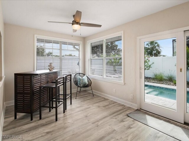 698 99th Ave N, Naples, FL 34108 - dining room with baseboards, light wood-type flooring, and ceiling fan