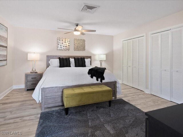 698 99th Ave N, Naples, FL 34108 - bedroom featuring baseboards, multiple closets, wood finished floors, and a ceiling fan