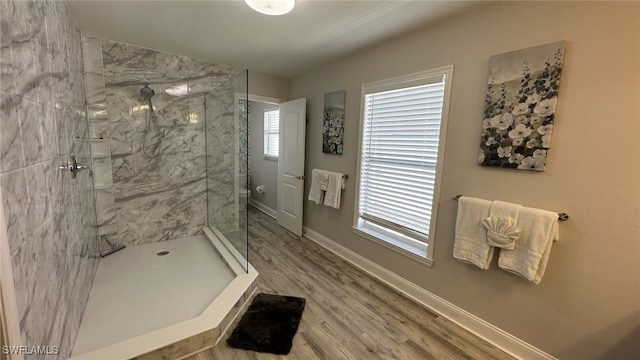 698 99th Ave N, Naples, FL 34108 - full bath with a marble finish shower, wood finished floors, and baseboards