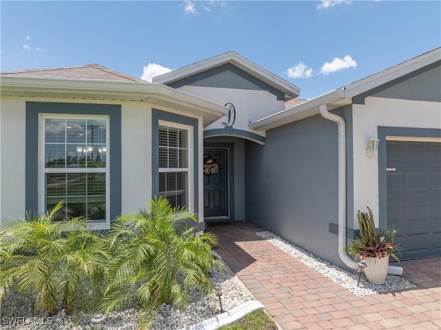 18 SW 19th Ter, Cape Coral, FL 33991 - property entrance with stucco siding and an attached garage