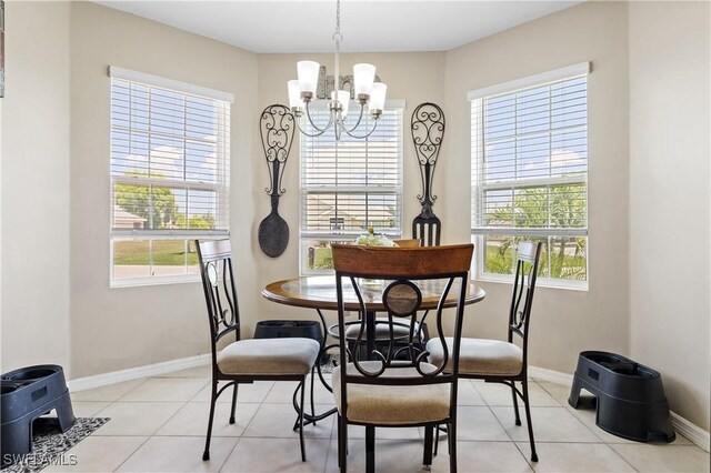 18 SW 19th Ter, Cape Coral, FL 33991 - dining space featuring a chandelier, baseboards, and light tile patterned flooring