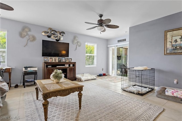 18 SW 19th Ter, Cape Coral, FL 33991 - living room featuring ceiling fan, light tile patterned floors, and baseboards