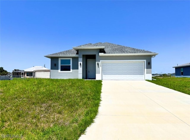 1064 Calumet Rd, Labelle, FL 33935 - prairie-style house featuring stucco siding, a garage, driveway, and a front yard