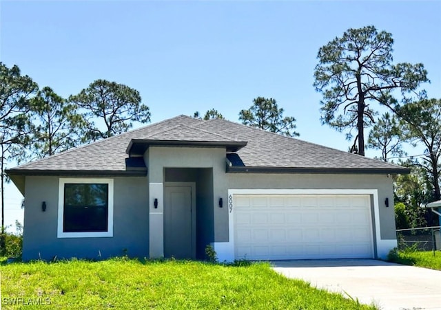 6007 Kumquat Cir, Labelle, FL 33935 - view of front facade with a shingled roof, stucco siding, an attached garage, and driveway